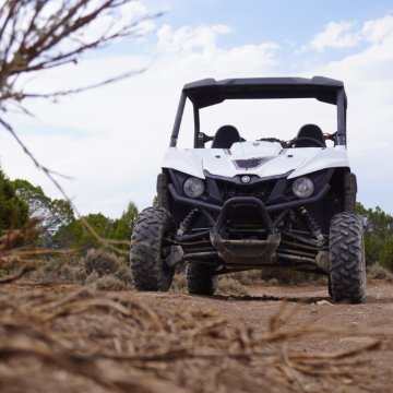 White UTV parked outside on a trail
